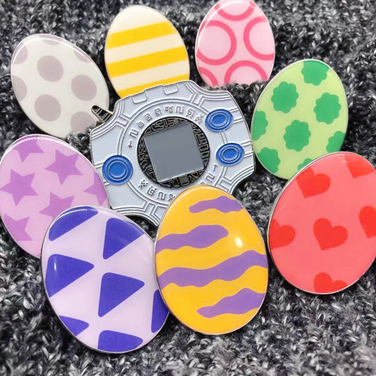 Huevos de Digimon y pines de esmalte de Digivice